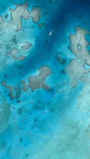 Stunning Aerial View of Tropical Coral Reef and Boat Wallpaper for Mobile