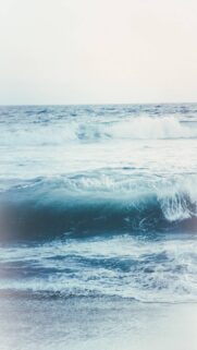 Stunning Ocean Waves Mobile Wallpaper in Soft Blue Hues