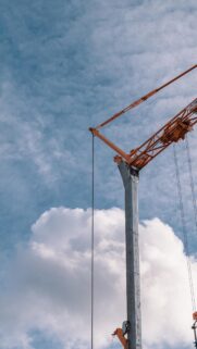 Industrial Construction Crane Against Blue Sky Mobile Wallpaper
