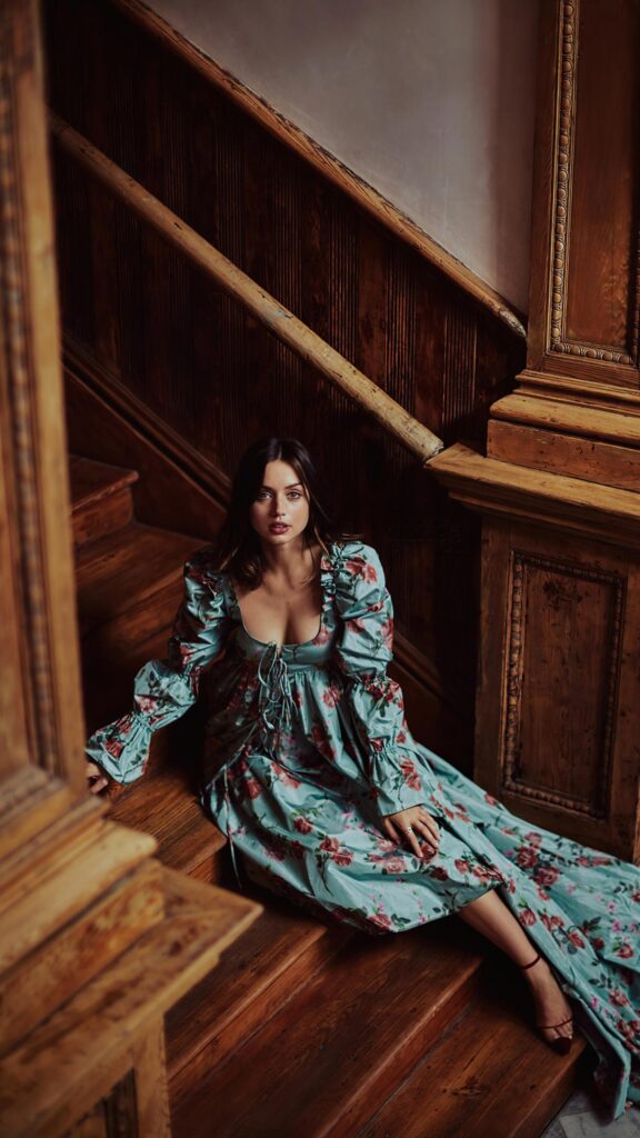 Ana de Armas in Floral Dress Sitting on Wooden Stairs Mobile Wallpaper
