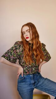 Sadie Sink Portrait with Red Hair and Floral Outfit Wallpaper