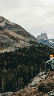 Solo Adventurer Looking at Mountains iPhone and Android Wallpaper