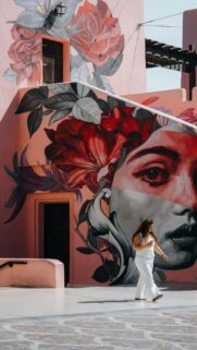 Woman Walking Past a Stunning Floral Face Mural Art Wallpaper