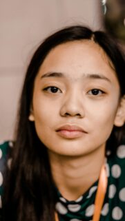 Stunning Portrait of a Young Asian Woman with Polka Dot Dress Wallpaper
