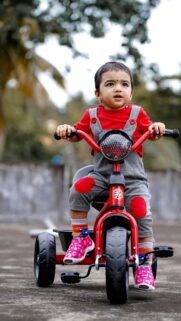 Cute Baby Riding Red Tricycle High-Resolution Mobile Wallpaper