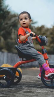 Cute Toddler Riding Red Tricycle High Quality Mobile Wallpaper