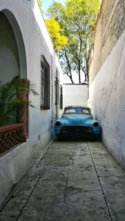 Abandoned Vintage Blue Car in Narrow Alleyway Aesthetic Wallpaper