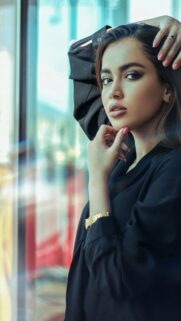 Elegant Woman in Black Portrait Phone Background Wallpaper