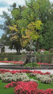 Majestic Pegasus Statue in Vibrant European Garden Palace Wallpaper