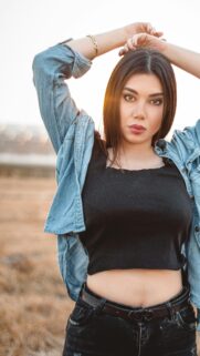Portrait of a Trendy Woman in Denim Shirt Mobile Wallpaper