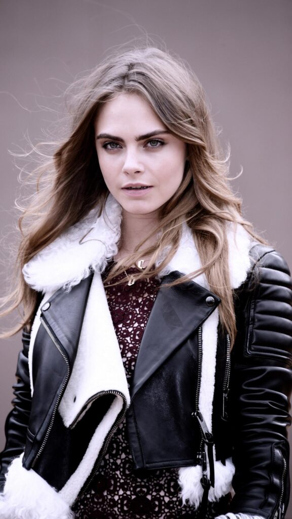 Stunning Portrait of Cara Delevingne in a Stylish Black Leather Jacket Wallpaper