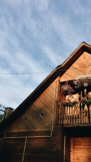 Rustic Wooden Cottage Balcony at Golden Hour Mobile Wallpaper