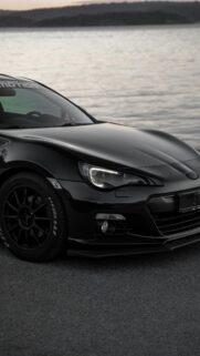 Sleek Black JDM Sports Car at Sunset Mobile Wallpaper