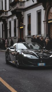 Black Ferrari 812 Superfast on Historic City Street Mobile Wallpaper