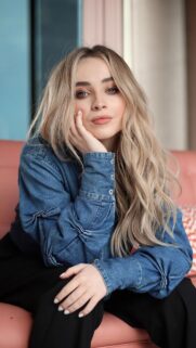 Stunning Portrait of Sabrina Carpenter in Denim Shirt Mobile Wallpaper