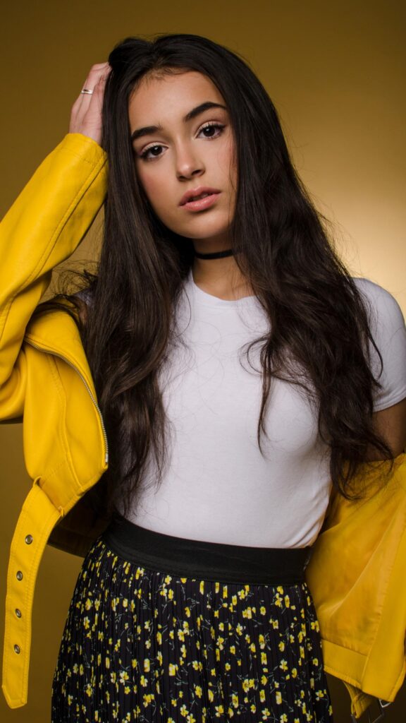 Beautiful Young Woman in Yellow Leather Jacket Portrait Wallpaper for Mobile