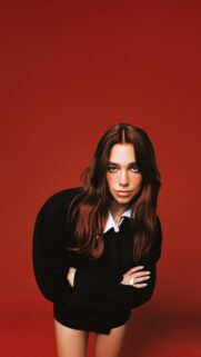 Stunning Dua Lipa Portrait Against Vibrant Red Background Mobile Wallpaper