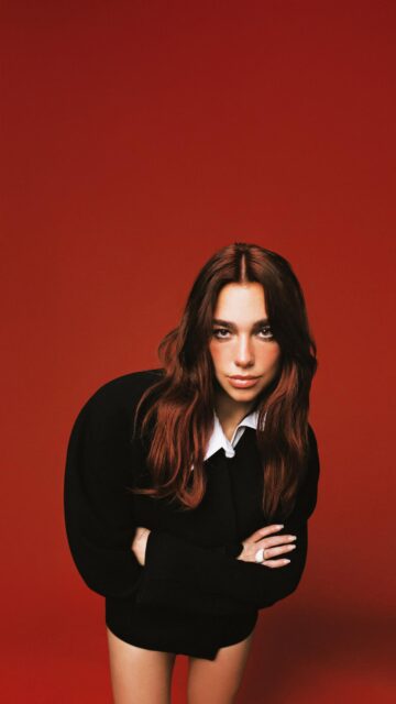 Stunning Dua Lipa Portrait Against Vibrant Red Background Mobile Wallpaper