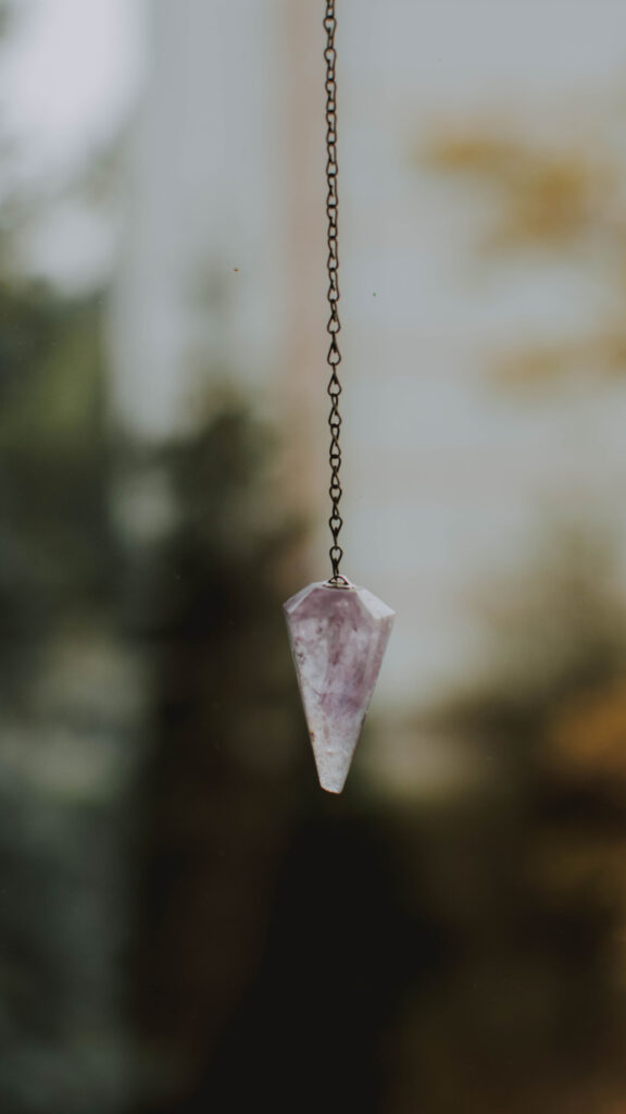 Amethyst Crystal Pendulum for Spiritual Clarity and Healing Energy Wallpaper