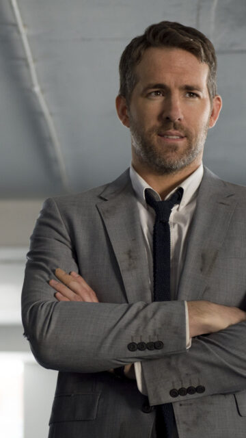 Ryan Reynolds in Grey Suit Portrait Mobile Wallpaper