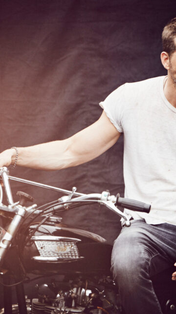 Man on Vintage Triumph Motorcycle Mobile Wallpaper