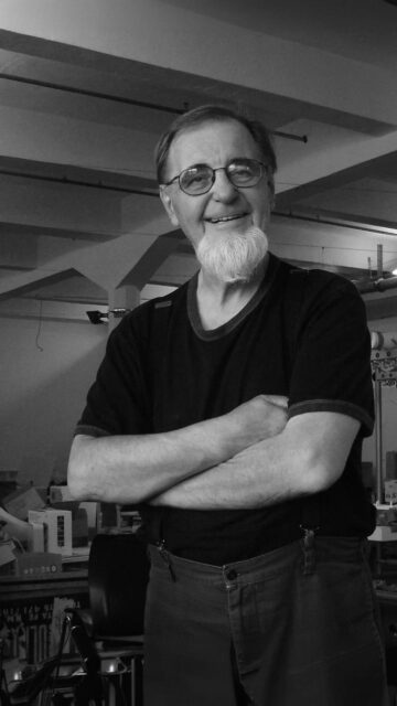 Portrait of a Bearded Elderly Man in a Workshop Mobile Wallpaper