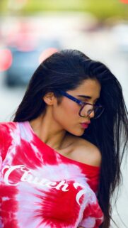Stylish Woman in Tie-Dye Top and Glasses Phone Wallpaper