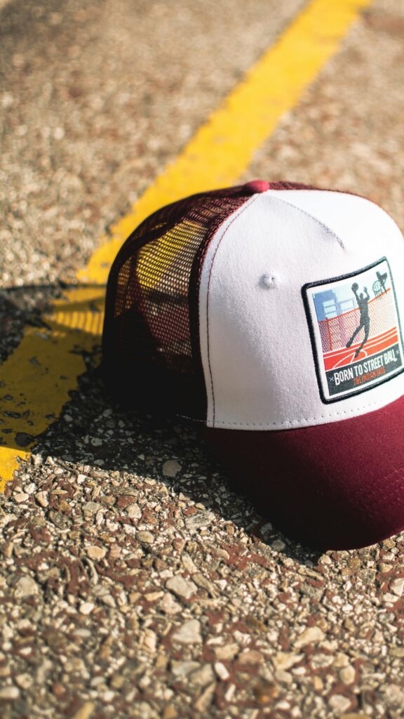 Maroon and White Street Basketball Trucker Hat on Asphalt Wallpaper