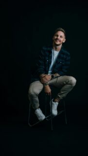 Stylish Man in Plaid Shirt Portrait Phone Wallpaper