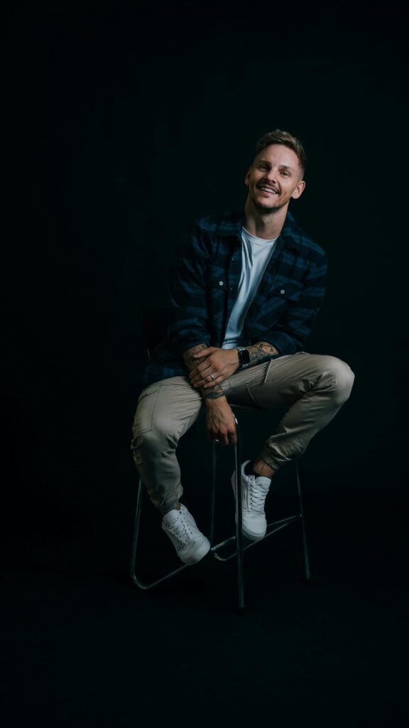 Stylish Man in Plaid Shirt Portrait Phone Wallpaper
