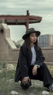 Stylish Woman in Fedora Hat and Oversized Blazer Aesthetic Wallpaper