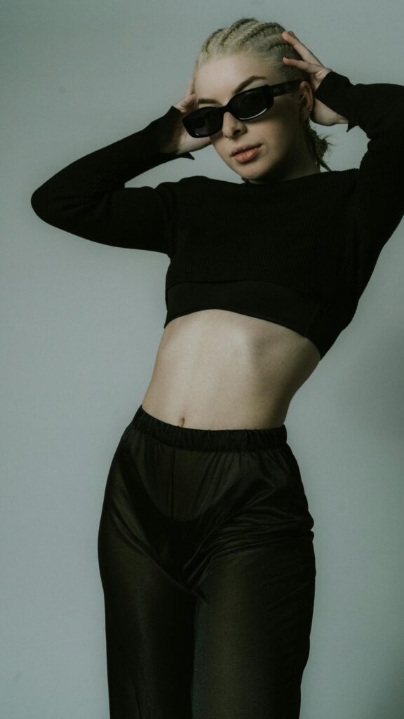 Stylish Blonde Woman in Black Crop Top and Sunglasses Portrait Wallpaper