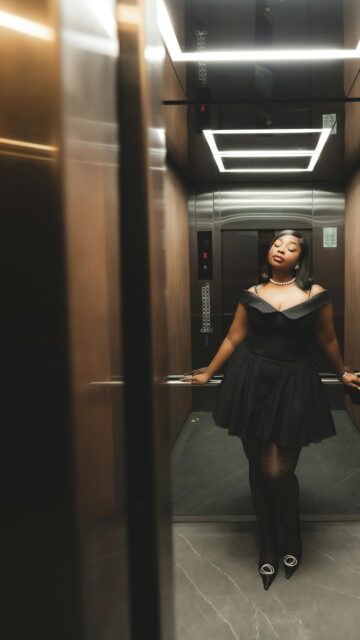 Elegant Woman in Little Black Dress Elevator Portrait Wallpaper