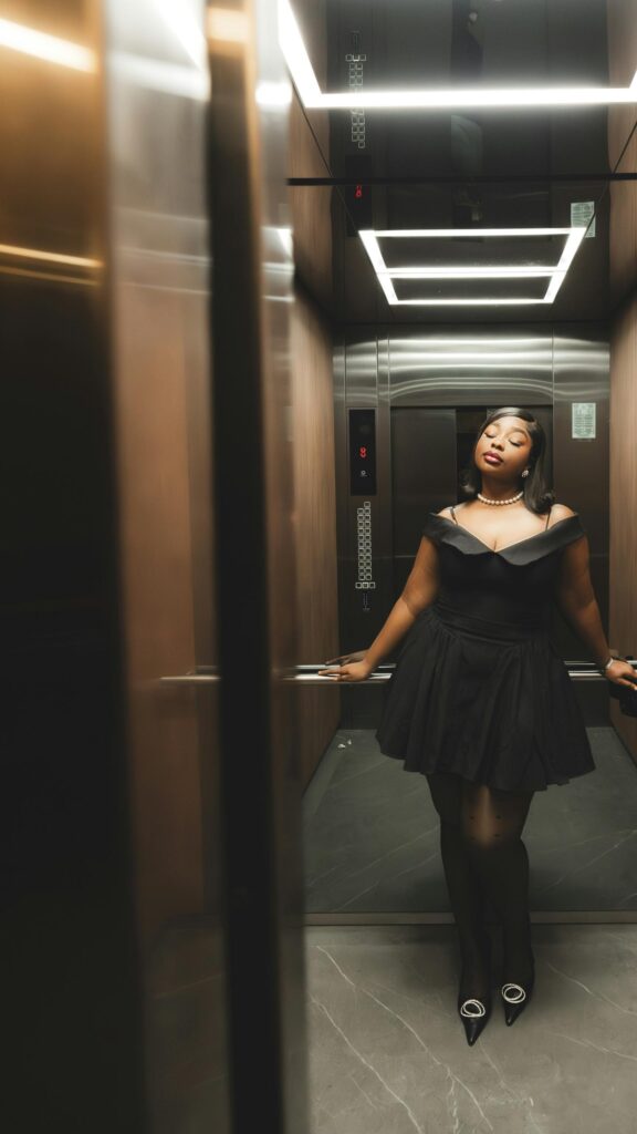 Elegant Woman in Little Black Dress Elevator Portrait Wallpaper