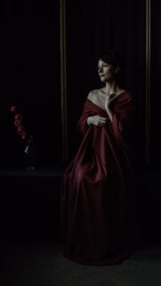 Elegant Woman in Deep Red Drape Portrait 4K Mobile Wallpaper