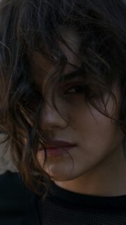 Stunning Close-up Portrait of a Mysterious Woman with Messy Hair Wallpaper