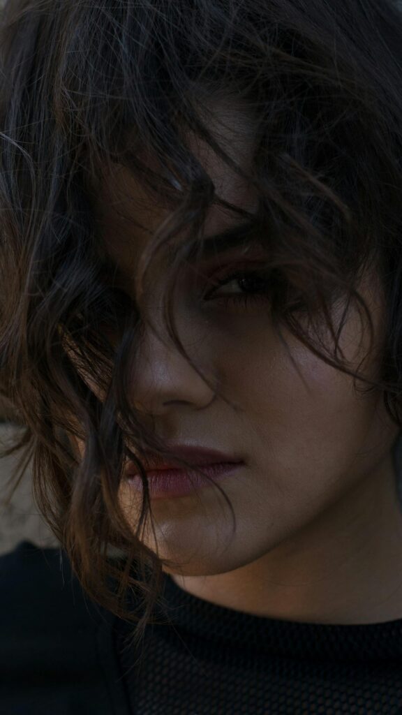 Stunning Close-up Portrait of a Mysterious Woman with Messy Hair Wallpaper