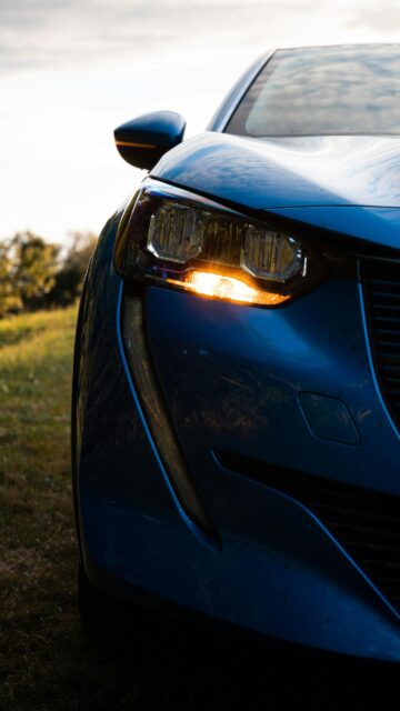 Blue Peugeot Car Front Headlight Close-up Mobile Wallpaper