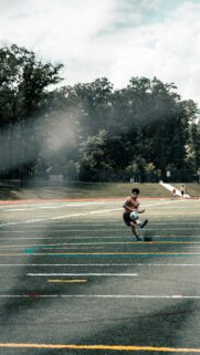Shirtless Soccer Player Training on Turf Field Mobile Wallpaper