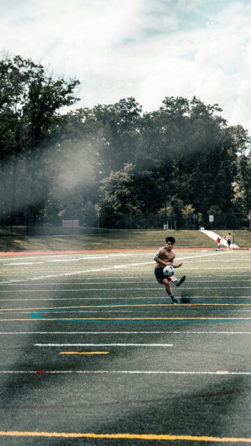 Shirtless Soccer Player Training on Turf Field Mobile Wallpaper