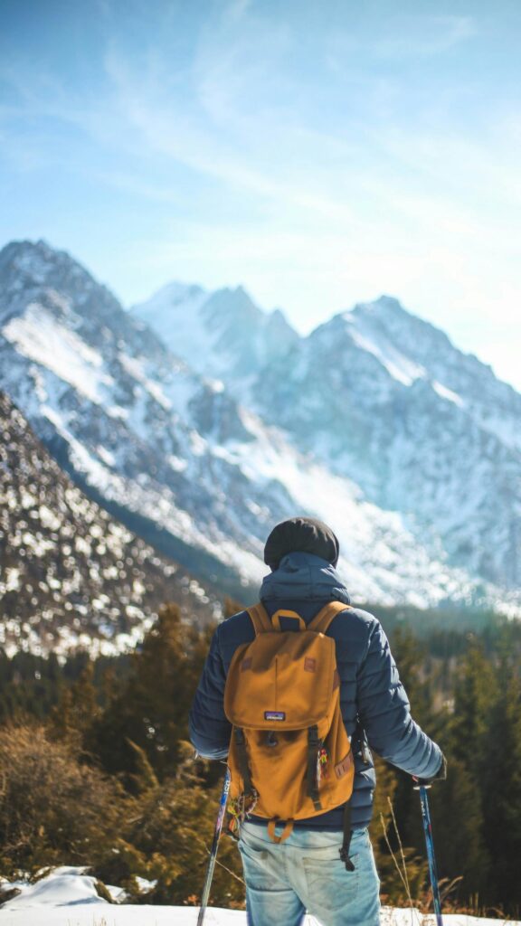 Hiker with Yellow Backpack Mountain View Mobile Wallpaper