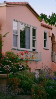 Charming Pink Stucco House with Garden Flowers Mobile Wallpaper