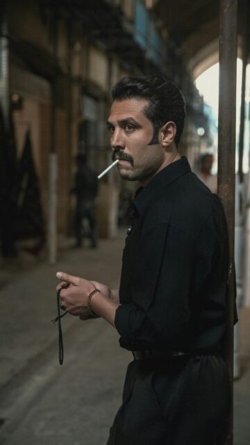 Man With Mustache Smoking Cigarette and Holding Prayer Beads Wallpaper