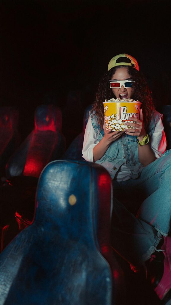 Cinematic Movie Night Popcorn Enthusiast Girl Mobile Wallpaper