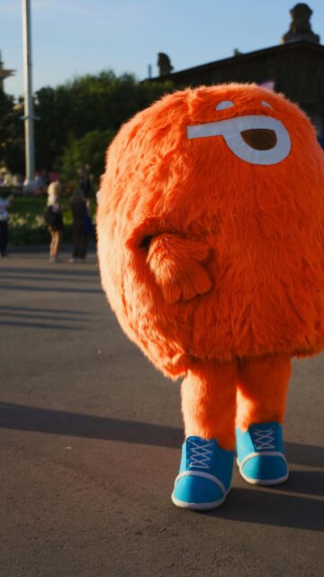 Cute Orange Furry Mascot Character Wearing Blue Sneakers Wallpaper