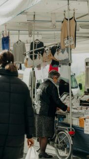 Elderly Woman Shopping at an Italian Outdoor Market Street Photography Wallpaper