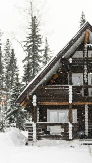 Cozy Snowy Log Cabin in Winter Forest Phone Wallpaper