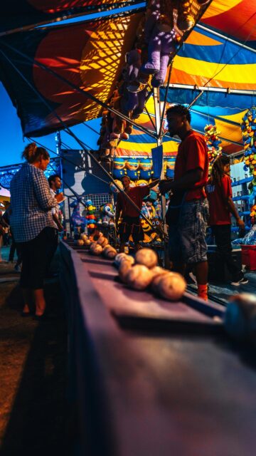 Fairground Carnival Game Stall at Twilight Mobile Wallpaper