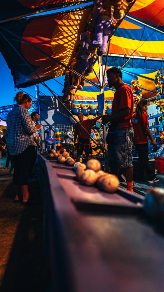 Fairground Carnival Game Stall at Twilight Mobile Wallpaper