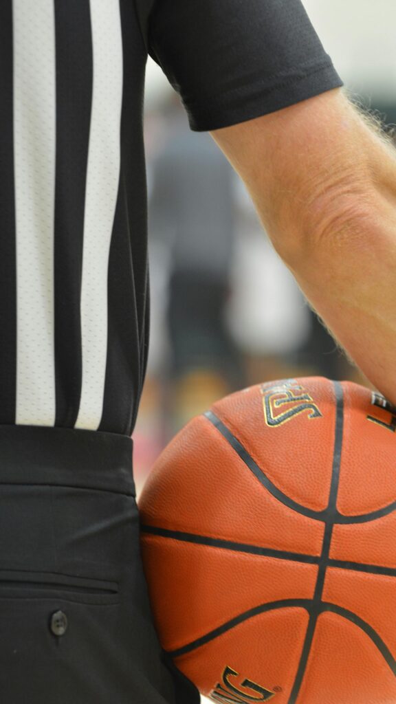 Basketball Referee Holding Official Game Ball Mobile Wallpaper